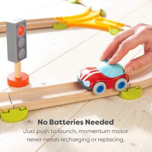 Toy car on a wooden track with a hand pushing it, accompanied by a traffic light and test saying how no batteries are needed