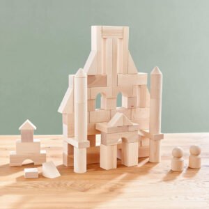 Basic Building Blocks 60 Piece Large Starter Set creating a wooden block castle featuring towers and arches, with smaller blocks and two round figures nearby on a wooden table.