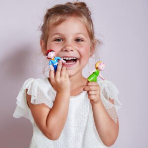 Child holding two small Little Friends figurines against a plain background
