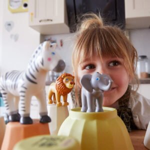 Child with Little Friends toy animals including a zebra, lion, and elephant in a kitchen setting
