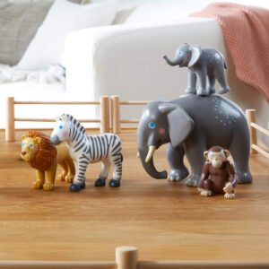 Little Friends toy animals including a lion, zebra, elephant, and monkey on a wooden floor.