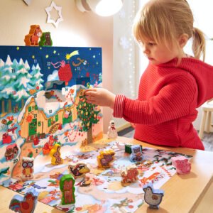 Toddler standing in a sunny room opening up a day on HABA's My First Advent Calendar with wooden farmyard animals already opened on the table