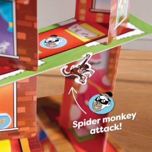 Close up of monkey game piece hanging off the Rhino Hero Super battle card tower with the words 