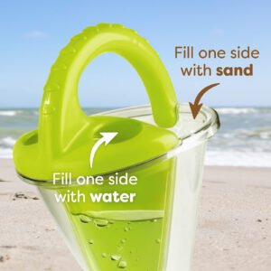 Close-up of a dual-compartment sand toy with a green handle on a beach. Text reads 